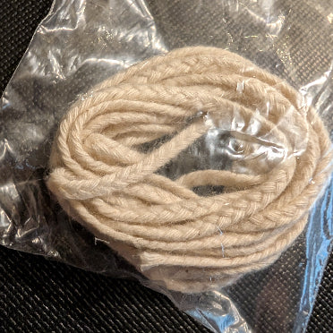 Coiled threads made for candle wicks. 3 threads contain various numbers of thinner threads to make the wick wider.