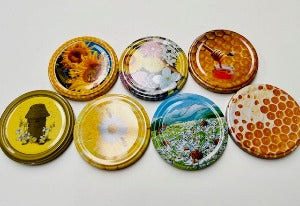 honey jar lids decorated with pictures of beautiful bees and bee inspire designs for australian honey and australian beekeeping for sale