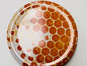honey jar lids decorated with pictures of beautiful bees and bee inspire designs for australian honey and australian beekeeping for sale